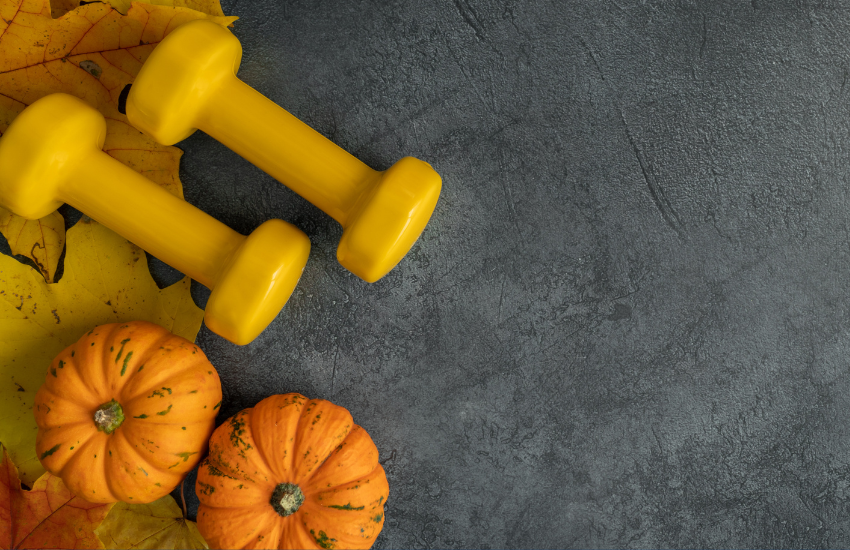 Yellow dumbbells with pumpkins and fall leaves